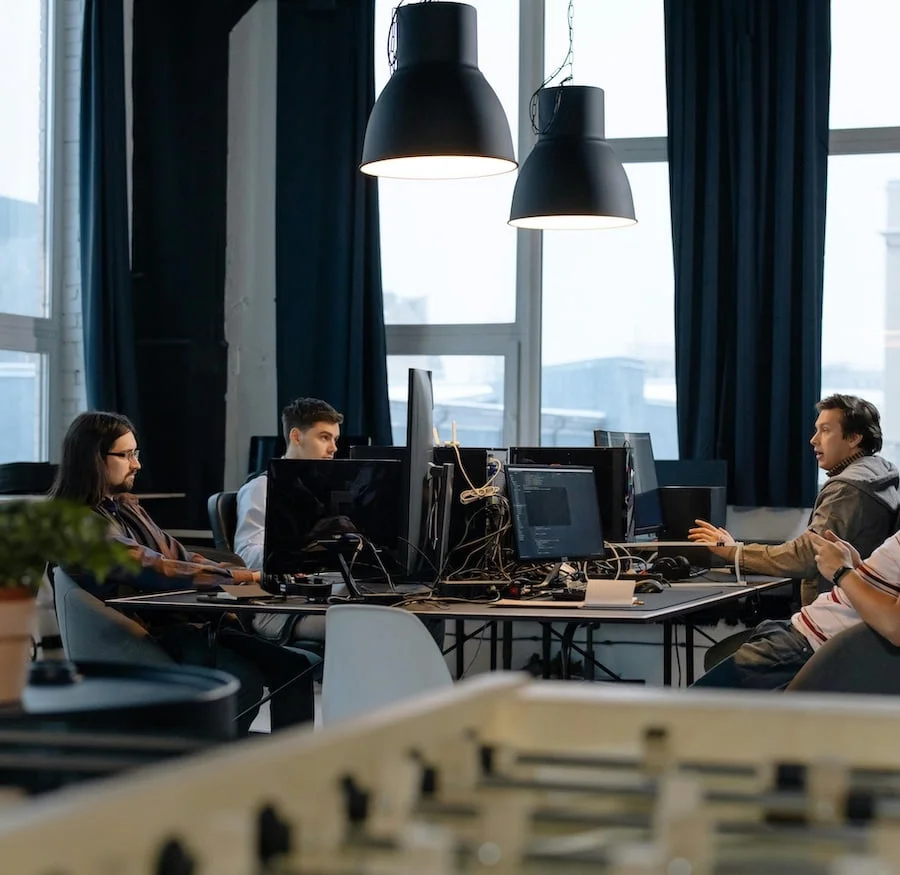 People working behind desks in office